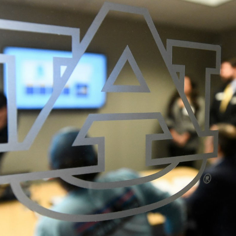 Photo of AU Logo on boardroom window