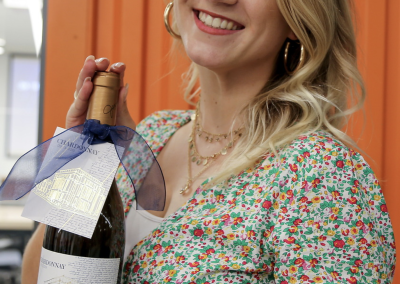 Kyra holding wine bottle at Horton Harbert Hardgrave opening