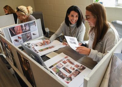 Melanie Duffey, left, talks with an interior design student in College of Human Sciences