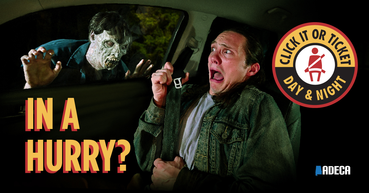 Zombie knocks on car window while driver buckles up. "In a hurry?"