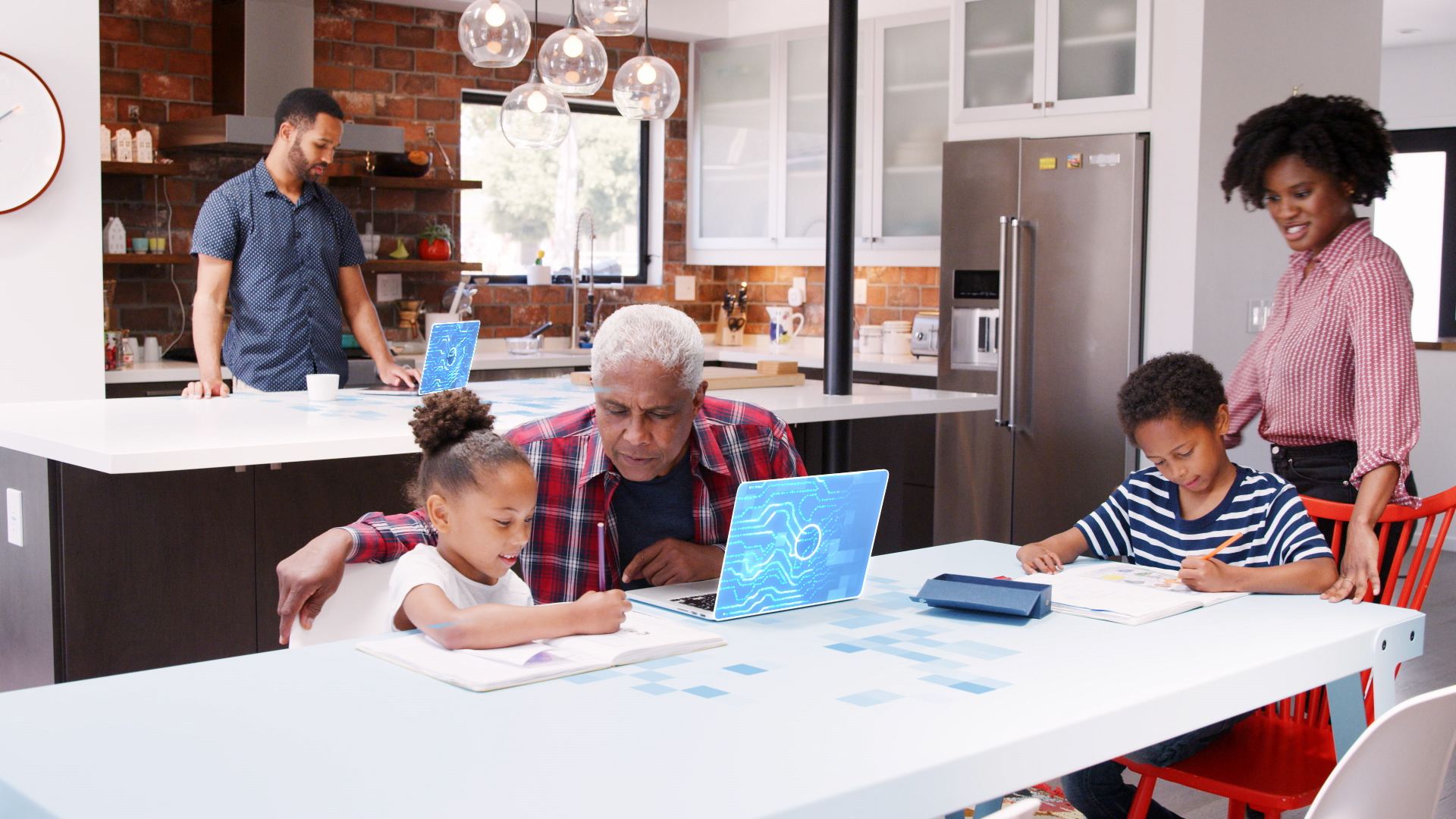 Tech elements illuminating laptops while family is in the kitchen